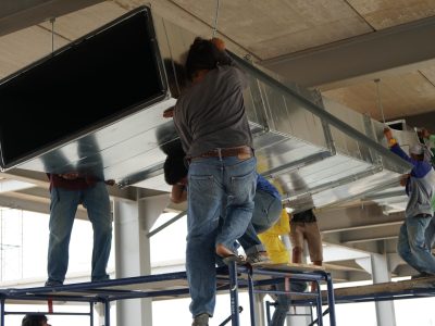 team-lifting-hvac-duct-in-a-construction-setting-2026-01-05-06-24-54-utc